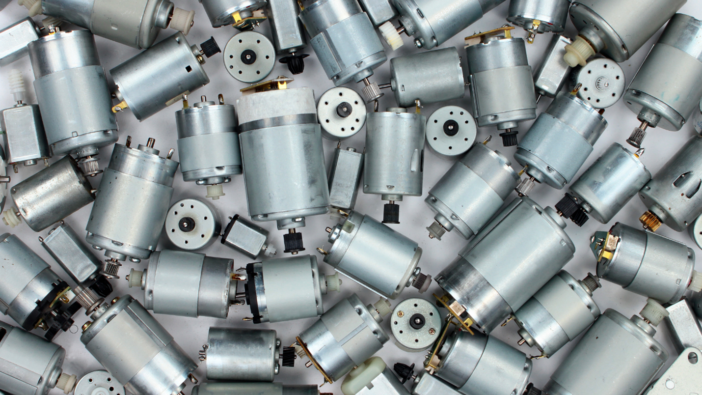 A stack of small x team motors and other similar devices, neatly arranged in a pile.