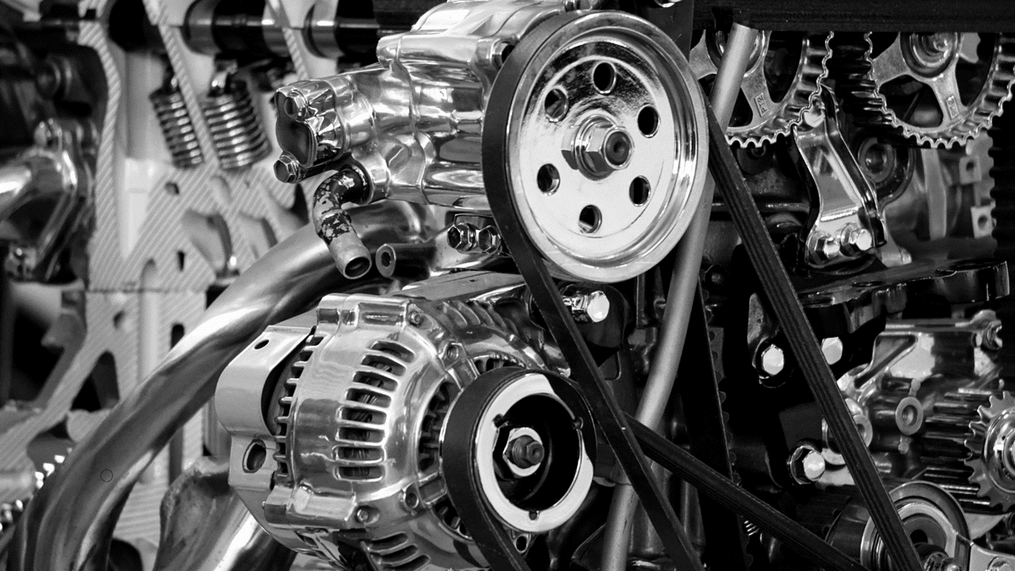 Black and white photo of a engine in which x team motor working, showcasing intricate mechanical parts and components.