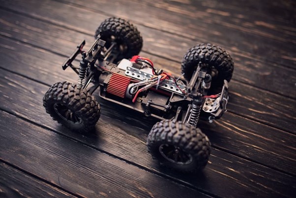 A remote-controlled toy car on a wooden floor, Made with Xteam Bldc Motor. Blog Image RC Brushless Motors 