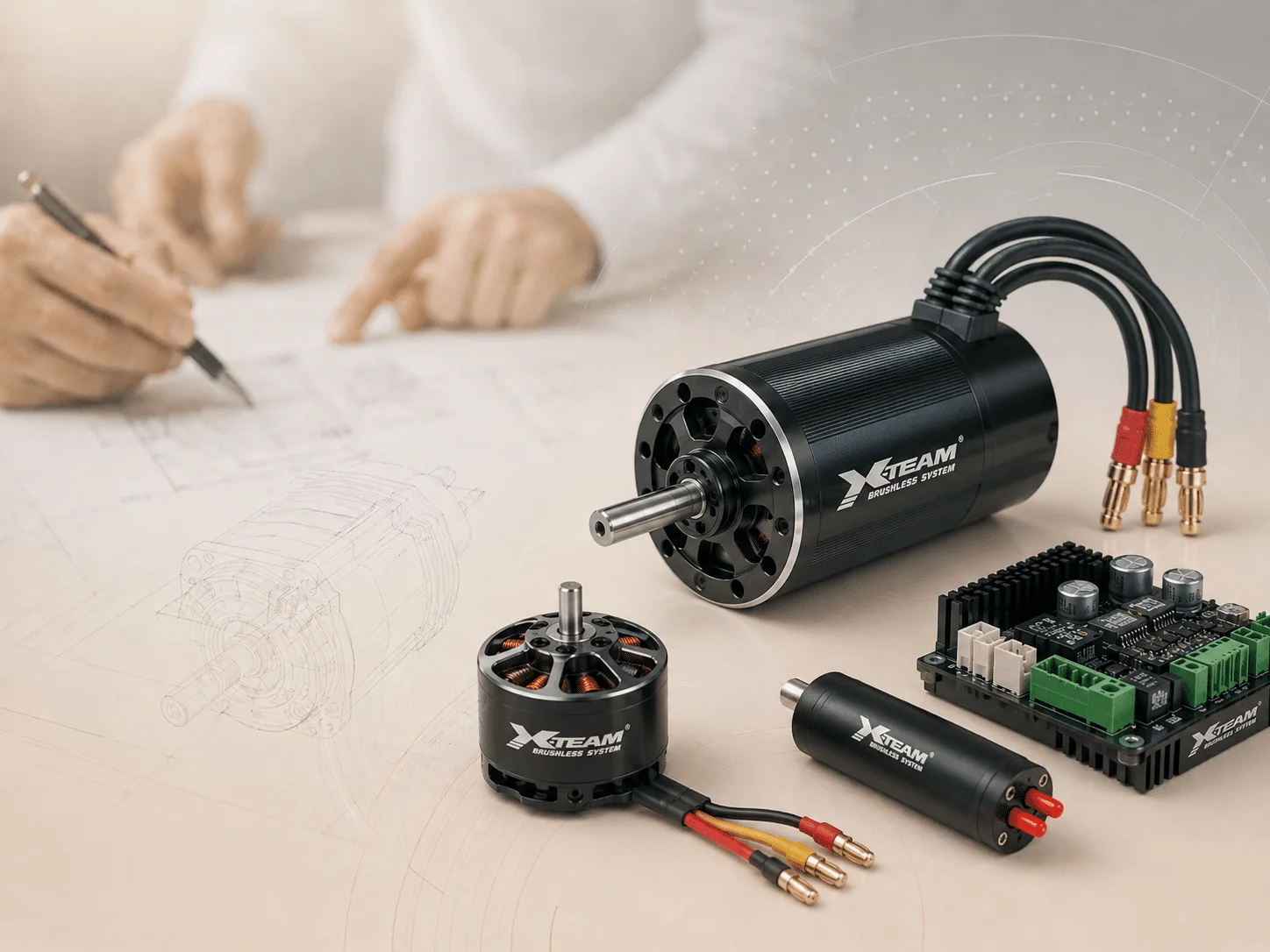 XTEAM brushless motor kit components on a workbench with engineering blueprints in the background.