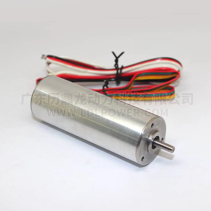 Small silver DC motor with a protruding shaft and a bundle of colored wires trailing behind.