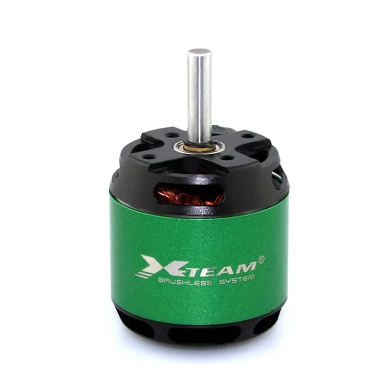 Green XTEAM brushless DC motor with a protruding silver shaft, black top, and green can body used in RC models.