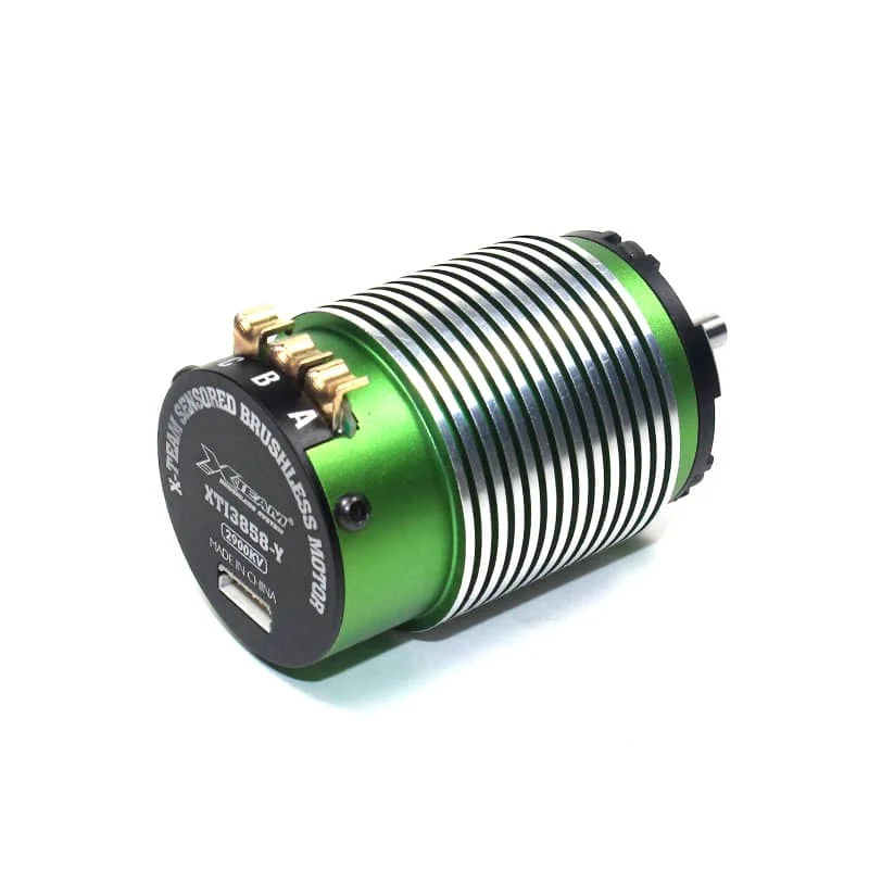 Green anodized brushless RC motor with cooling fins and gold terminal lugs labeled A and B on the side edge (compact cylindrical design).