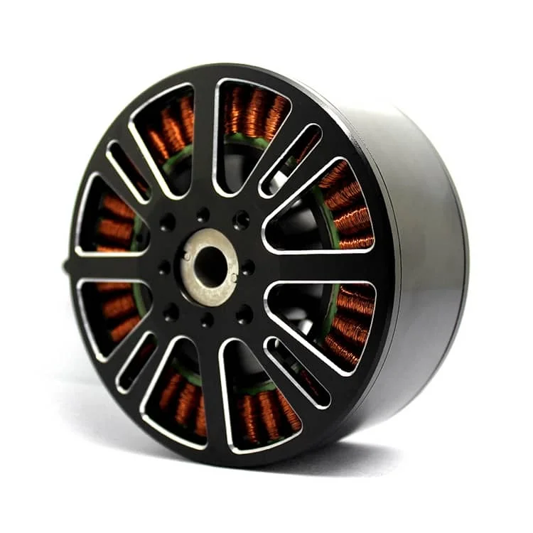 Close-up of a circular electric motor stator with orange copper windings visible in black spokes